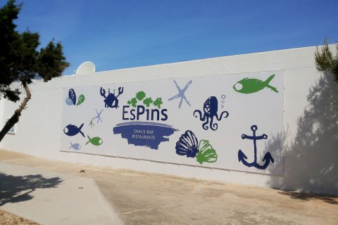 Diseño gráfico  y logo de restaurante "Es Pins" sobre lona colgado en la pared.